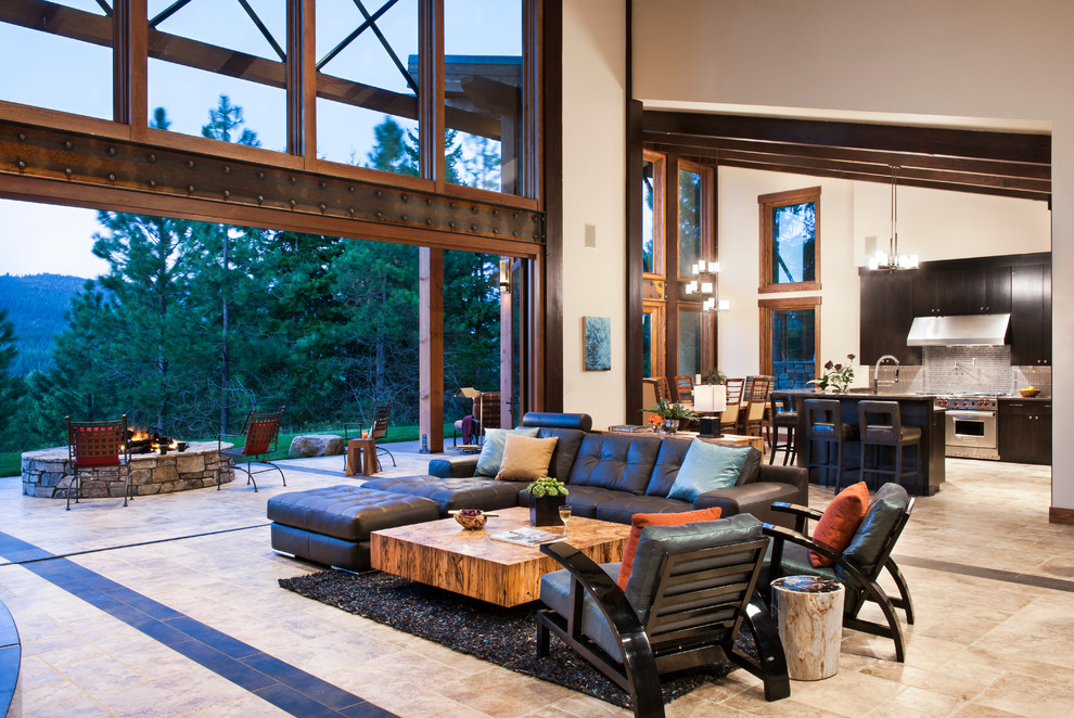 This is an example of a large rustic formal open plan living room in Seattle with no tv, white walls, travertine flooring, a standard fireplace, a metal fireplace surround and beige floors.