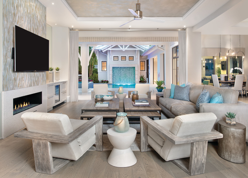Beach style open plan living room in Miami with a home bar, a ribbon fireplace, a tiled fireplace surround and a wall mounted tv.
