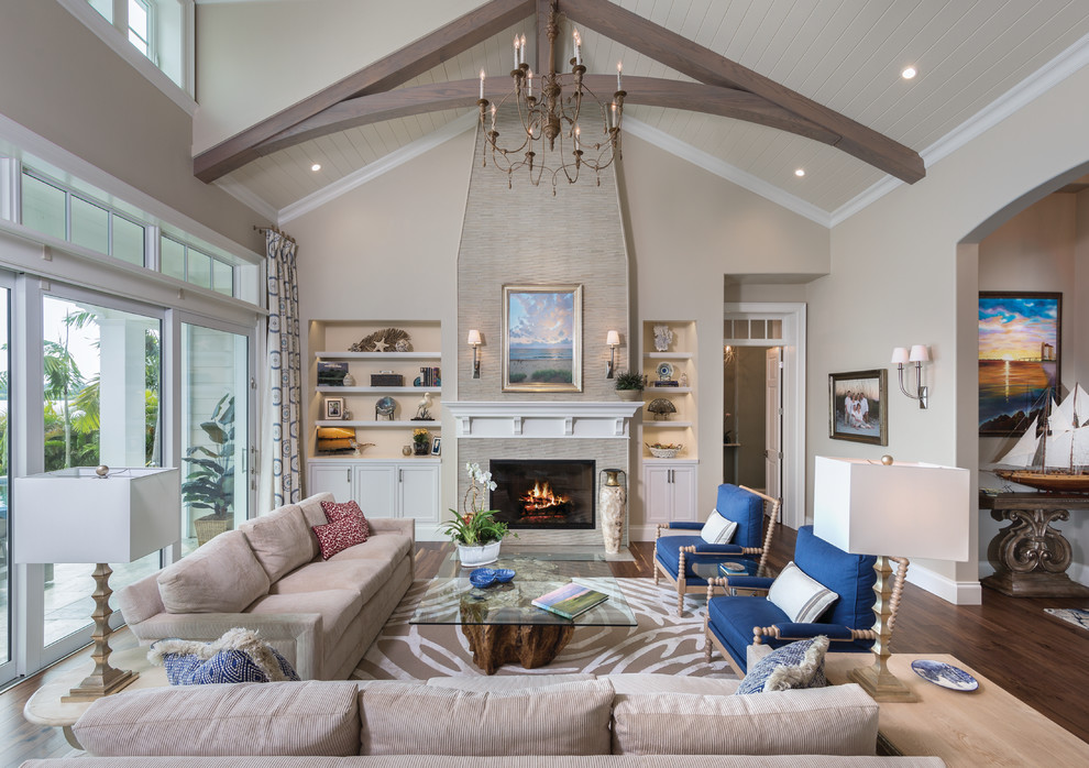 Living room - large coastal formal and open concept dark wood floor living room idea in Miami with beige walls, a standard fireplace and no tv