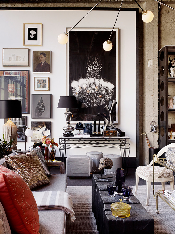 This is an example of a bohemian living room in San Francisco with white walls and feature lighting.