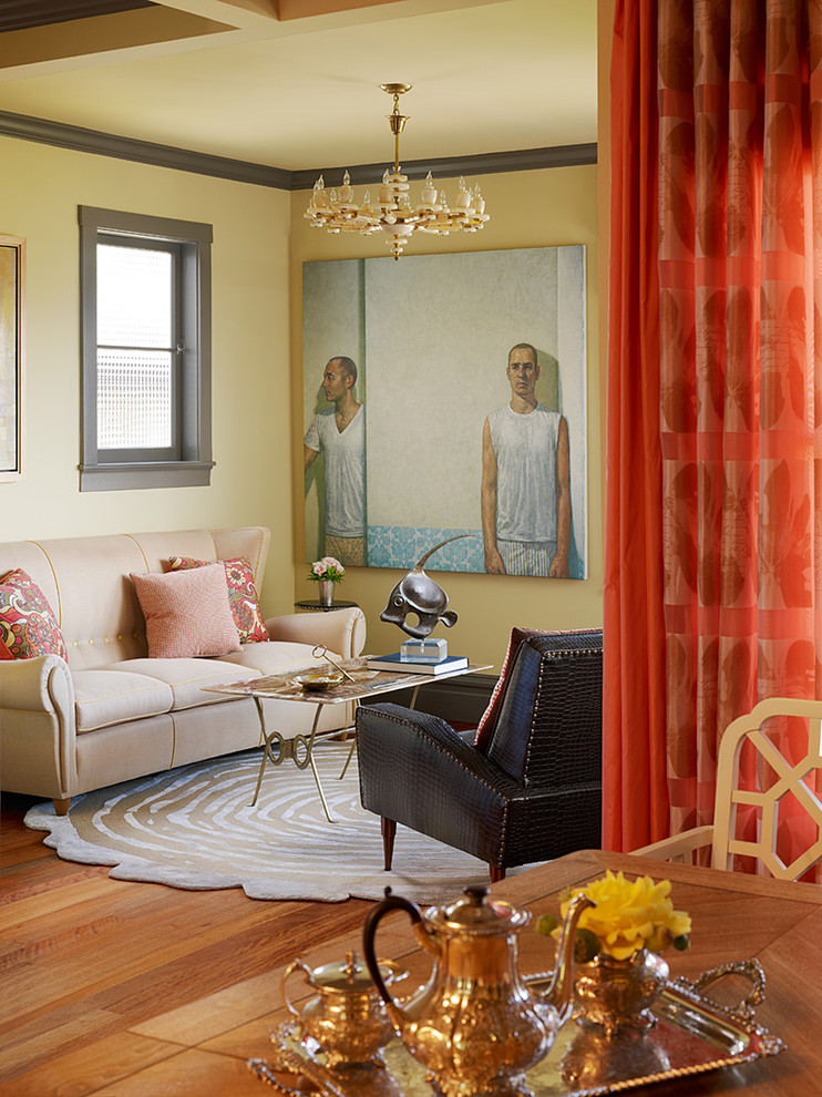 This is an example of an eclectic living room in San Francisco with yellow walls and medium hardwood flooring.