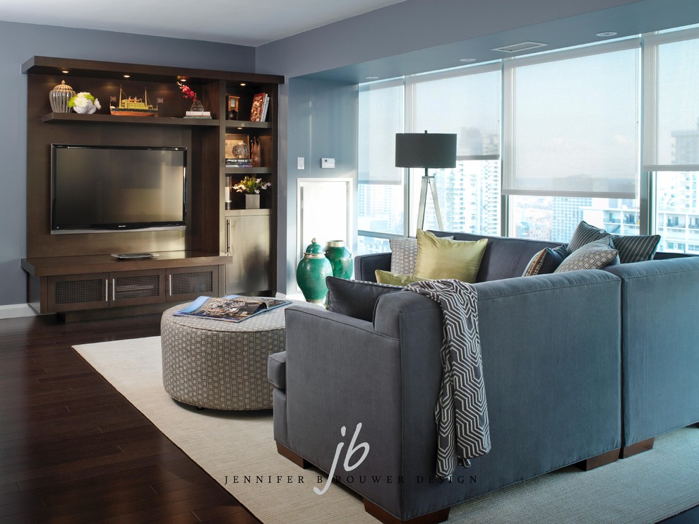 Small contemporary open plan living room in Toronto with grey walls, medium hardwood flooring and a built-in media unit.