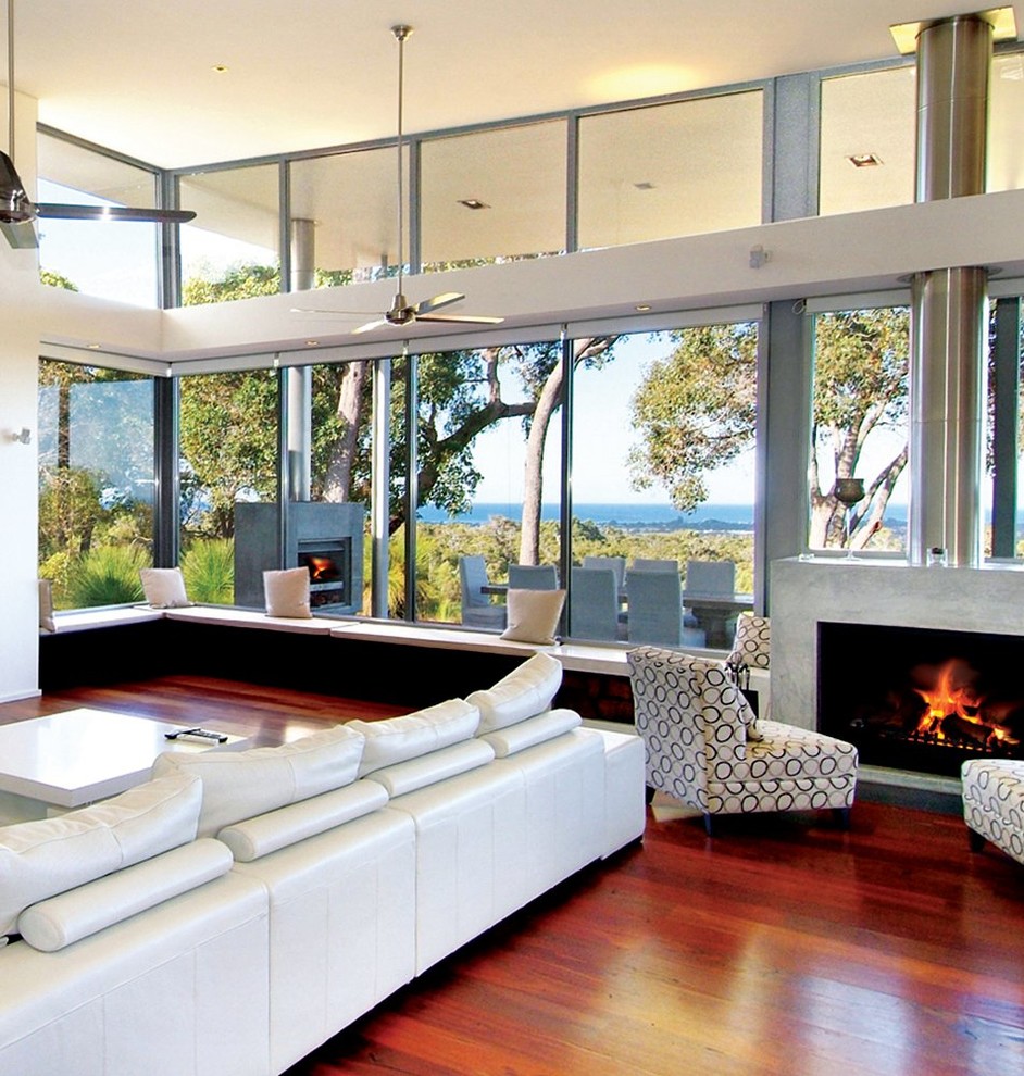 Photo of a medium sized beach style living room in Perth with white walls, dark hardwood flooring, a standard fireplace, a concrete fireplace surround and no tv.