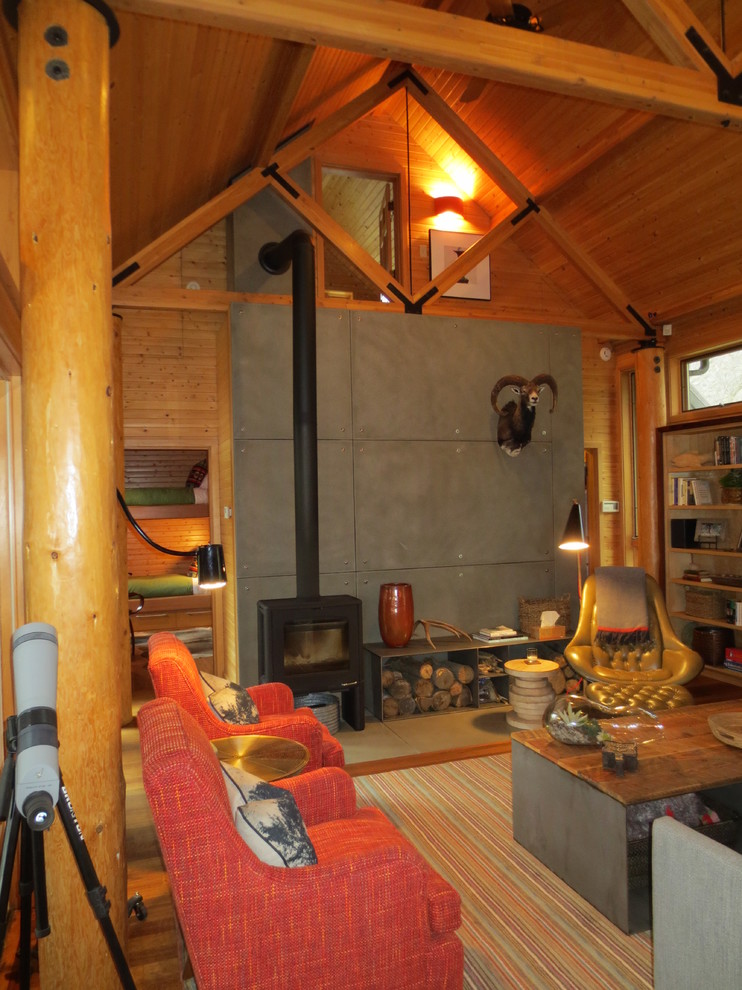 Diseño de salón tipo loft rústico pequeño con estufa de leña y marco de chimenea de hormigón