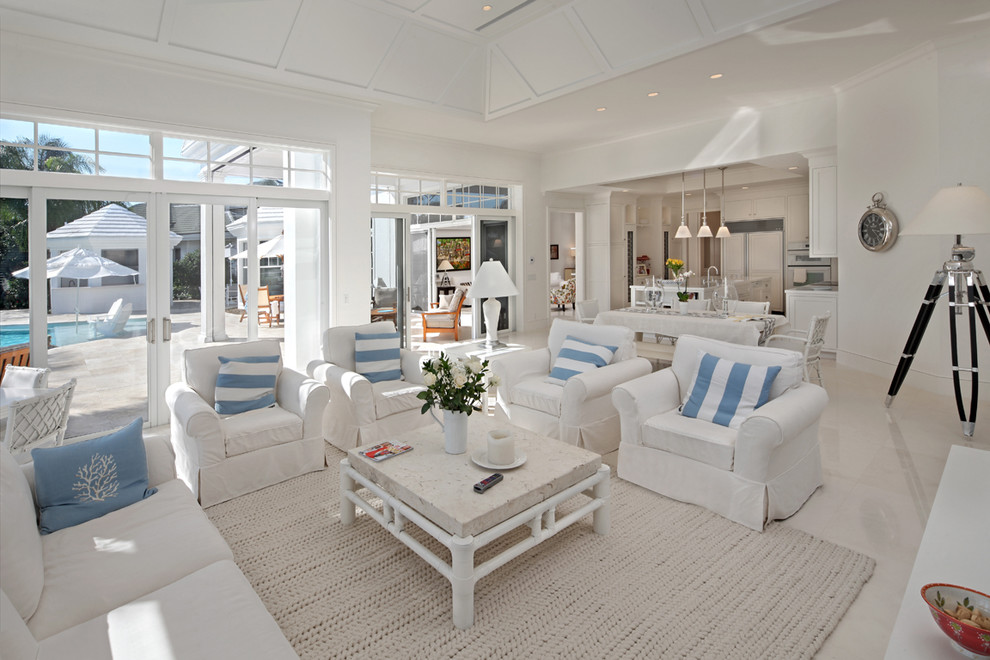 Island style white floor living room photo in Miami with white walls
