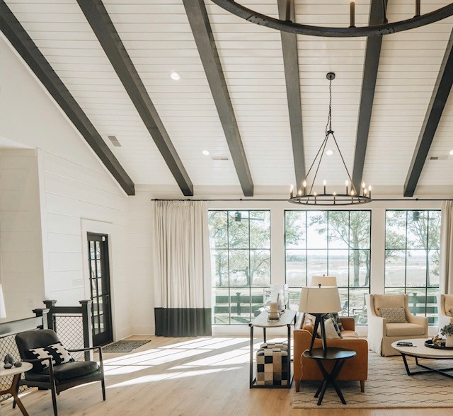 Design ideas for a large coastal open plan living room in Charleston with exposed beams and wood walls.
