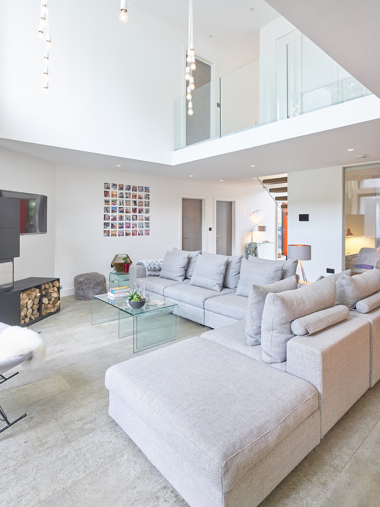 This is an example of a contemporary formal living room in West Midlands with white walls and grey floors.