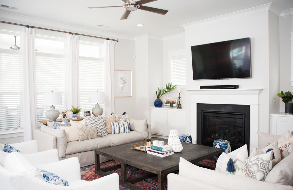 Design ideas for a nautical living room in Charleston with white walls, a standard fireplace and a wall mounted tv.