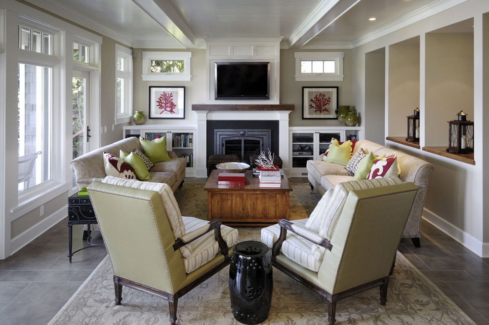 Photo of a large traditional living room in Seattle with beige walls, a standard fireplace and a wall mounted tv.