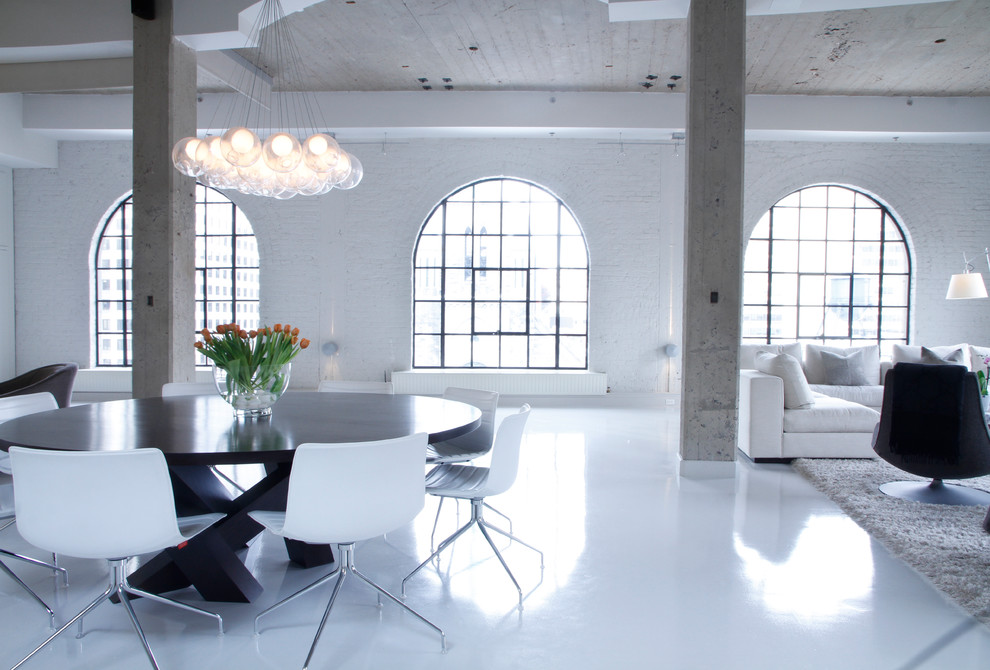 Example of a huge urban white floor living room design in Montreal with white walls