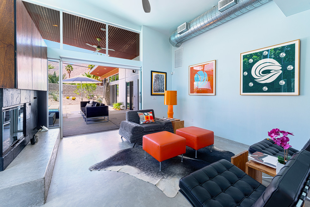 Ispirazione per un soggiorno minimalista con pareti blu e pavimento in cemento