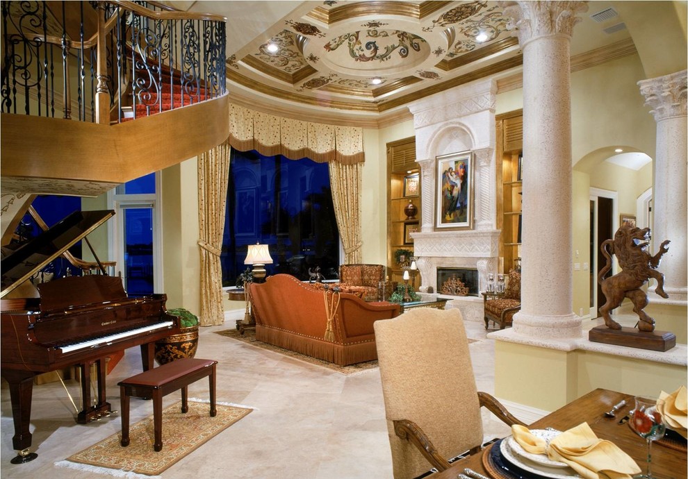 На фото: большая парадная, открытая гостиная комната в средиземноморском стиле с мраморным полом, стандартным камином, фасадом камина из камня и бежевыми стенами без телевизора