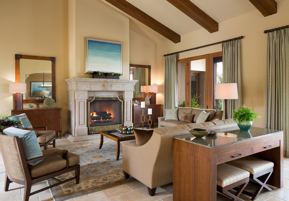Photo of a mediterranean living room in Phoenix with beige walls and a standard fireplace.