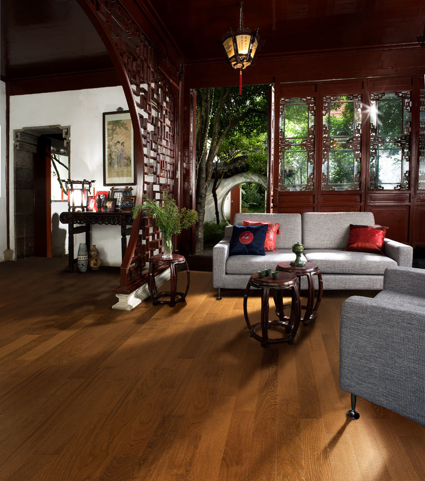 Example of a mid-sized zen open concept medium tone wood floor living room design in Chicago with white walls and no tv