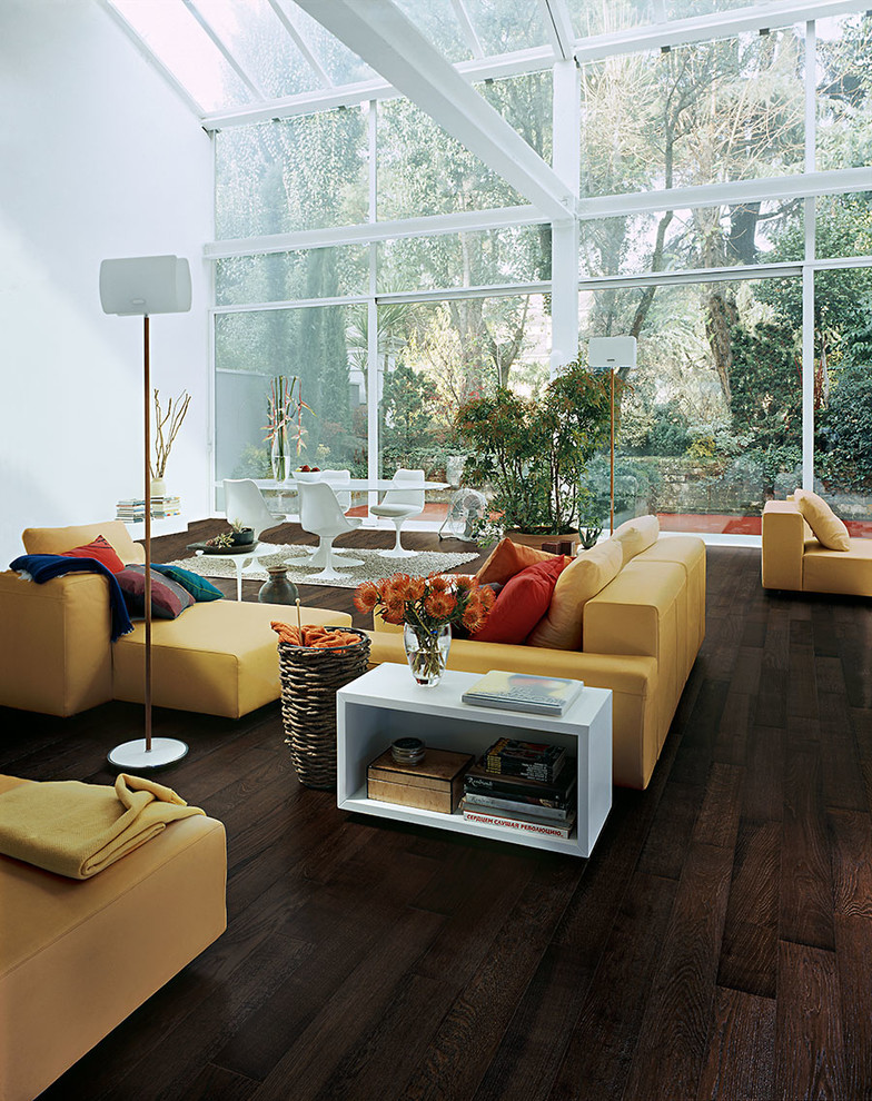 Inspiration for an expansive industrial open plan living room in Chicago with white walls and dark hardwood flooring.
