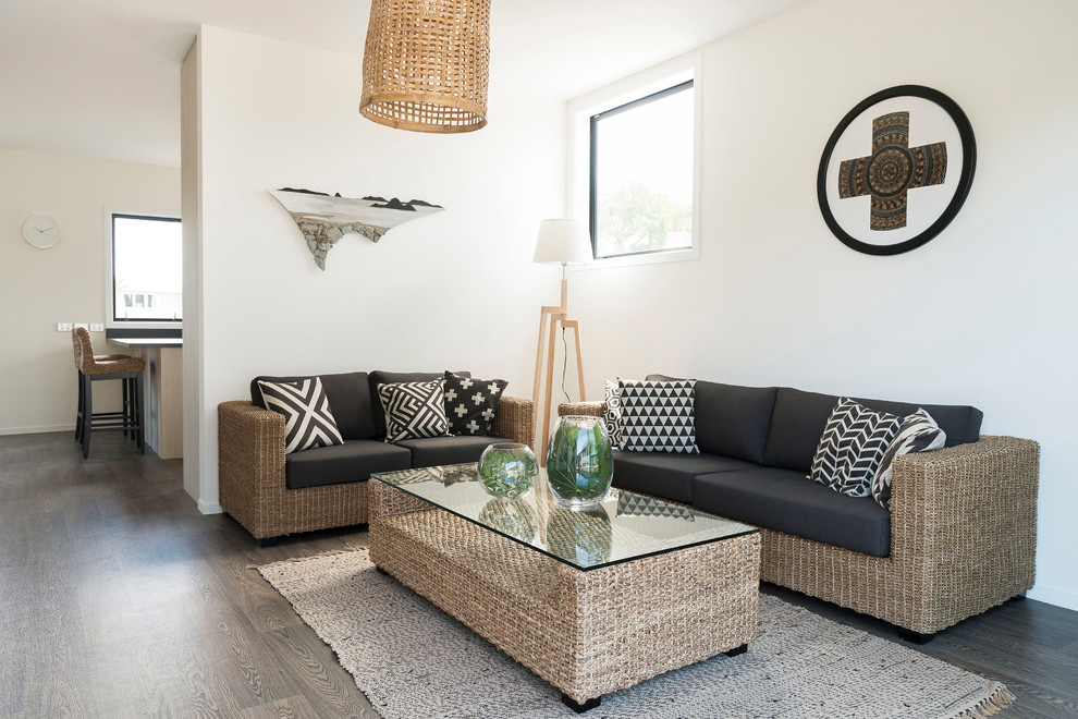 Nautical living room in Auckland with white walls, dark hardwood flooring and black floors.