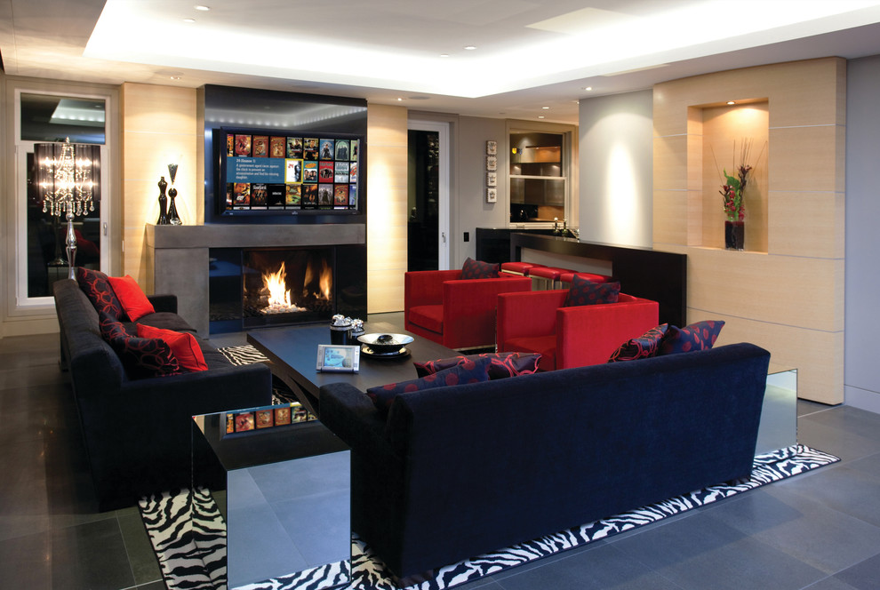Example of a minimalist enclosed slate floor living room design in Orange County with a standard fireplace, a concrete fireplace and a wall-mounted tv
