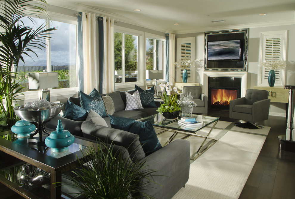 Photo of a classic grey and teal living room in Denver with grey walls and a standard fireplace.