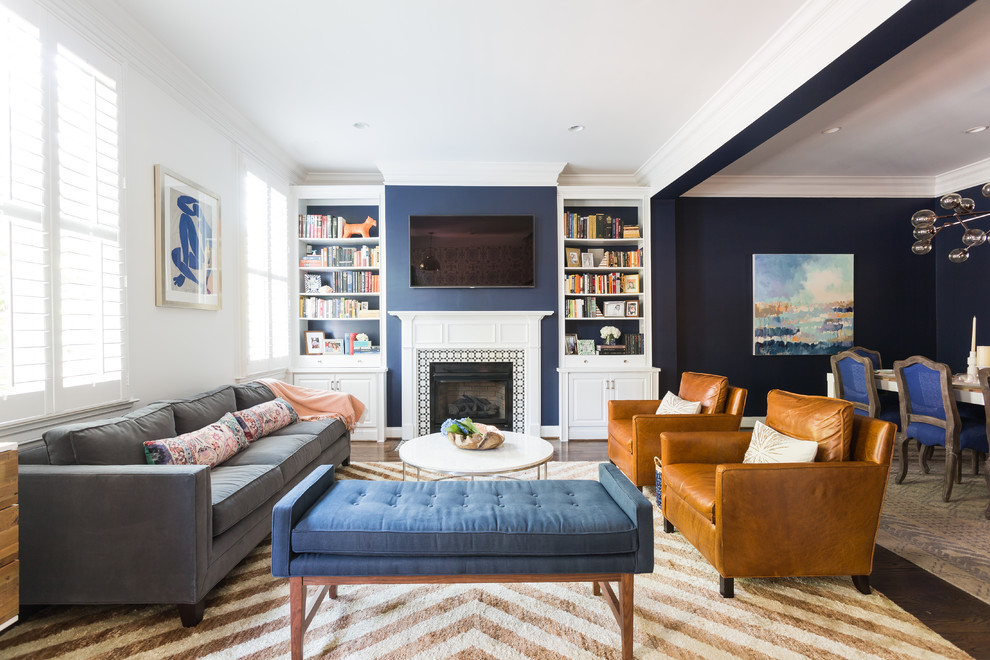 Example of a transitional formal and open concept dark wood floor living room design in DC Metro with blue walls, a standard fireplace, a tile fireplace and a wall-mounted tv