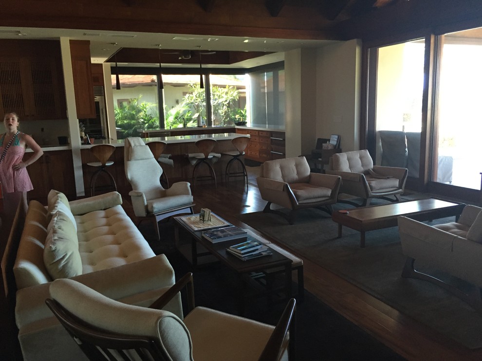 Mittelgroßes, Repräsentatives, Fernseherloses, Offenes Wohnzimmer ohne Kamin mit beiger Wandfarbe und braunem Holzboden in Hawaii