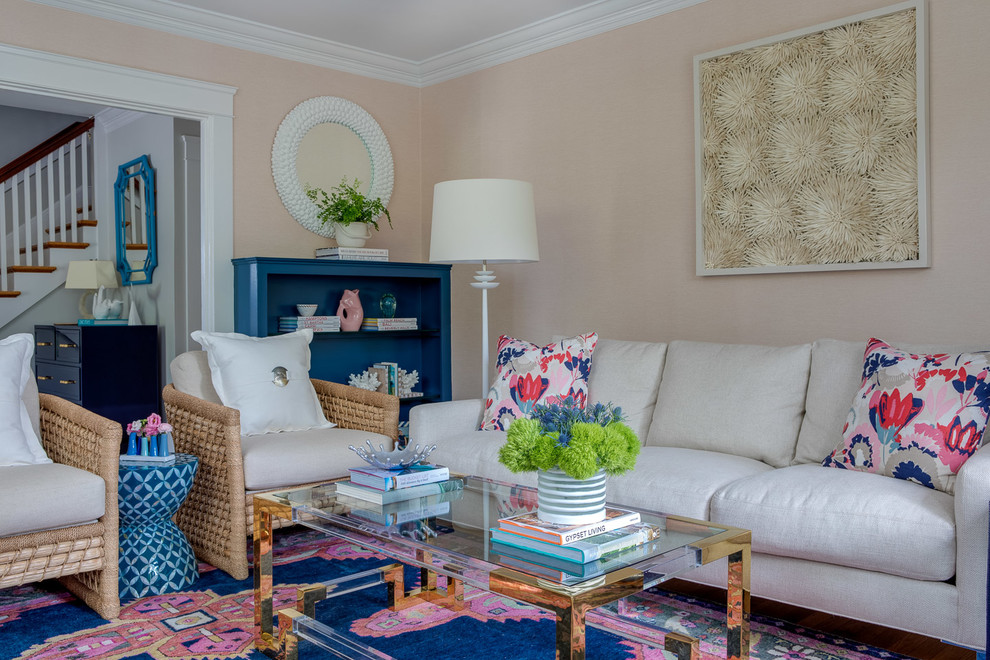 На фото: гостиная комната в морском стиле с с книжными шкафами и полками, розовыми стенами и ковром на полу с