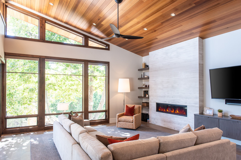 Inspiration for a large 1950s open concept medium tone wood floor and brown floor living room remodel in Salt Lake City with white walls, a ribbon fireplace, a tile fireplace and a tv stand