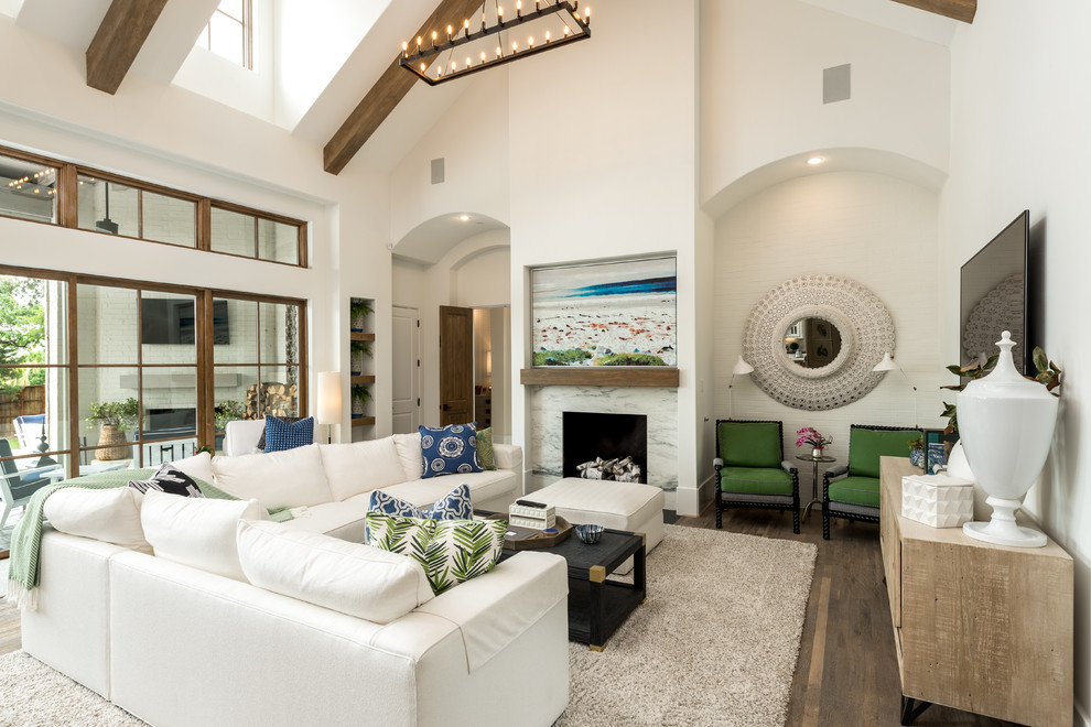 Design ideas for a classic formal open plan living room in Dallas with white walls, medium hardwood flooring, a standard fireplace, a stone fireplace surround, a wall mounted tv and brown floors.