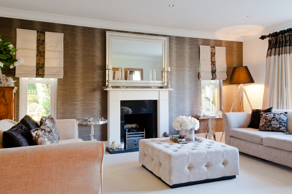 This is an example of a medium sized traditional formal enclosed living room in Surrey with multi-coloured walls, carpet, a standard fireplace, a concrete fireplace surround and no tv.