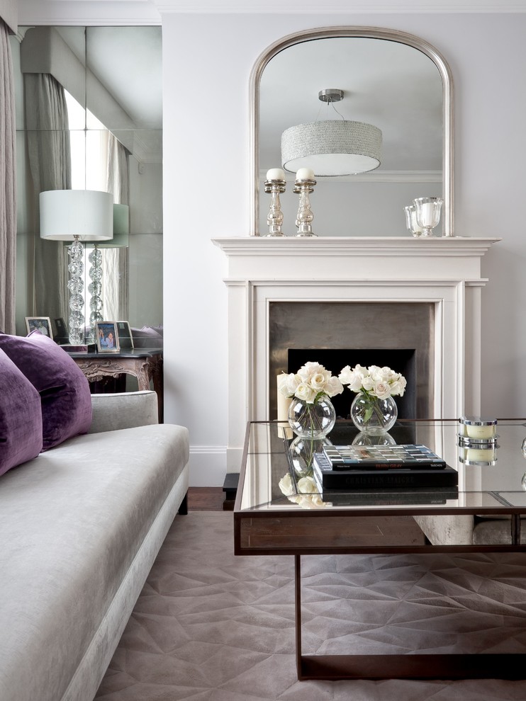 Example of a mid-sized trendy dark wood floor living room design in London with white walls, a standard fireplace and a metal fireplace