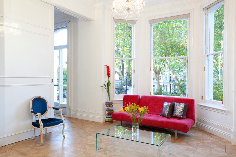 Living room - scandinavian light wood floor living room idea in London with white walls