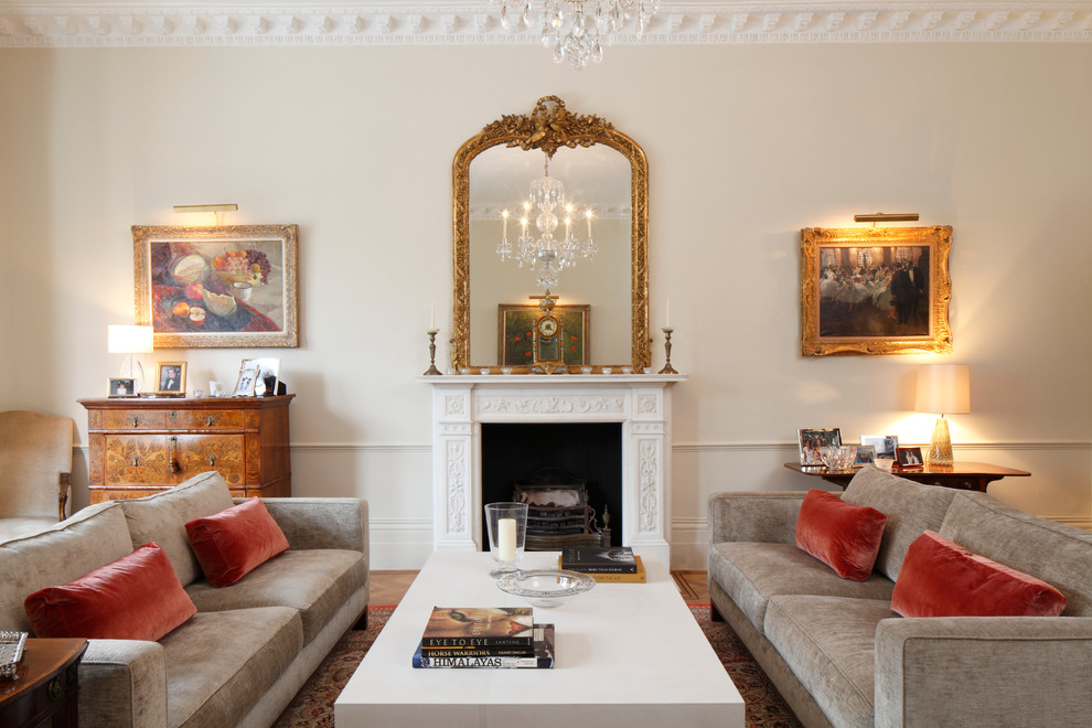 Example of a classic enclosed living room design in London with a standard fireplace