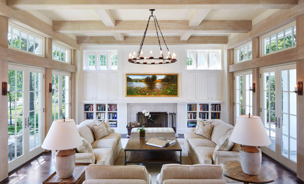 Photo of a classic living room in Minneapolis with white walls, dark hardwood flooring, a standard fireplace, brown floors and exposed beams.