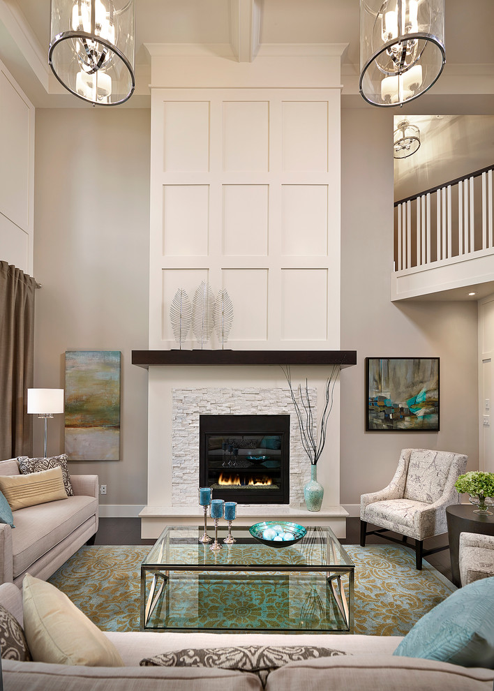 Inspiration for a classic living room in Edmonton with beige walls, a standard fireplace, a stone fireplace surround and feature lighting.