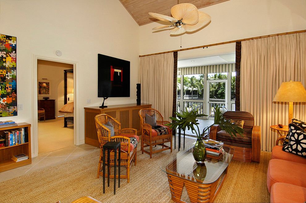 This is an example of a world-inspired living room in Miami with white walls and beige floors.