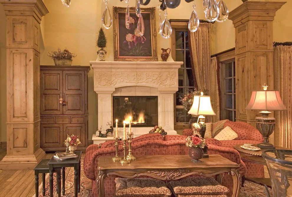 Idée de décoration pour un grand salon tradition ouvert avec une salle de réception, un mur beige, un sol en bois brun, une cheminée standard, un manteau de cheminée en pierre et aucun téléviseur.