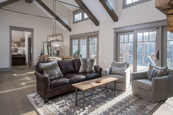 Inspiration for a medium sized classic open plan living room in Other with grey walls, dark hardwood flooring, a standard fireplace, a stone fireplace surround, a freestanding tv and brown floors.