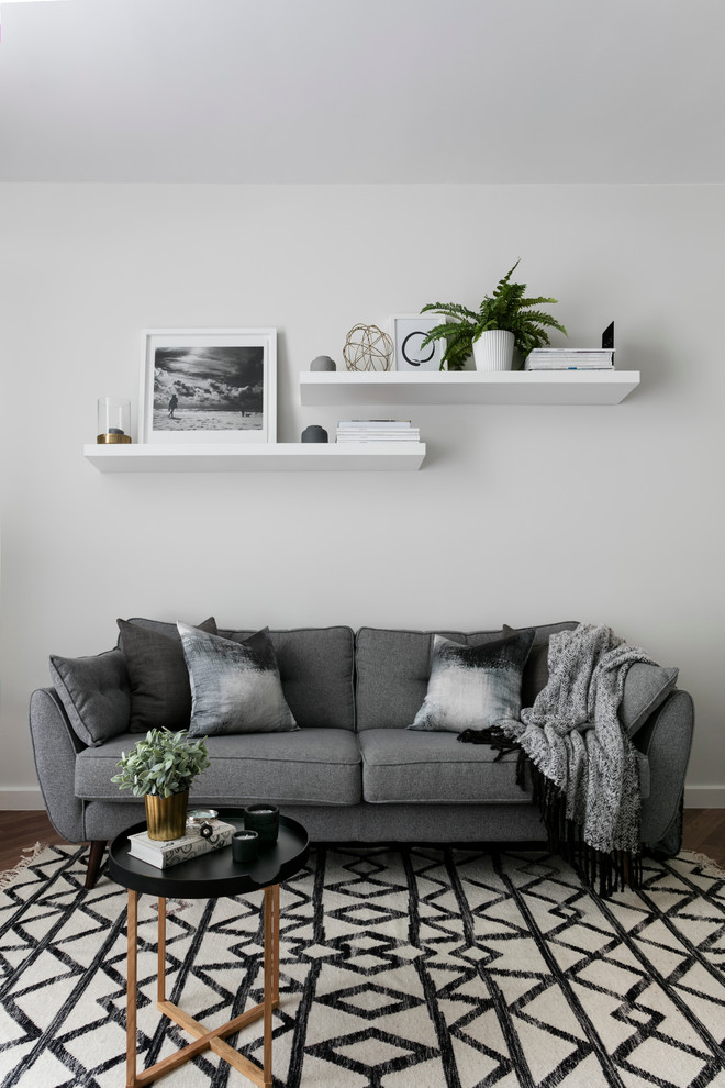 Living room - scandinavian living room idea in London with white walls