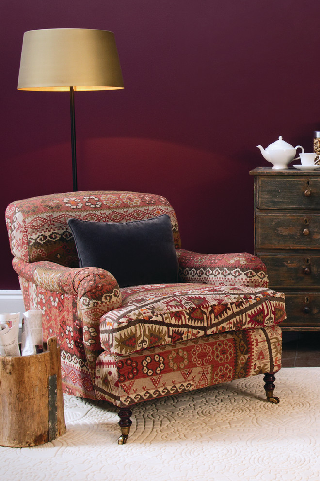Photo of a medium sized world-inspired enclosed living room in London with red walls and carpet.