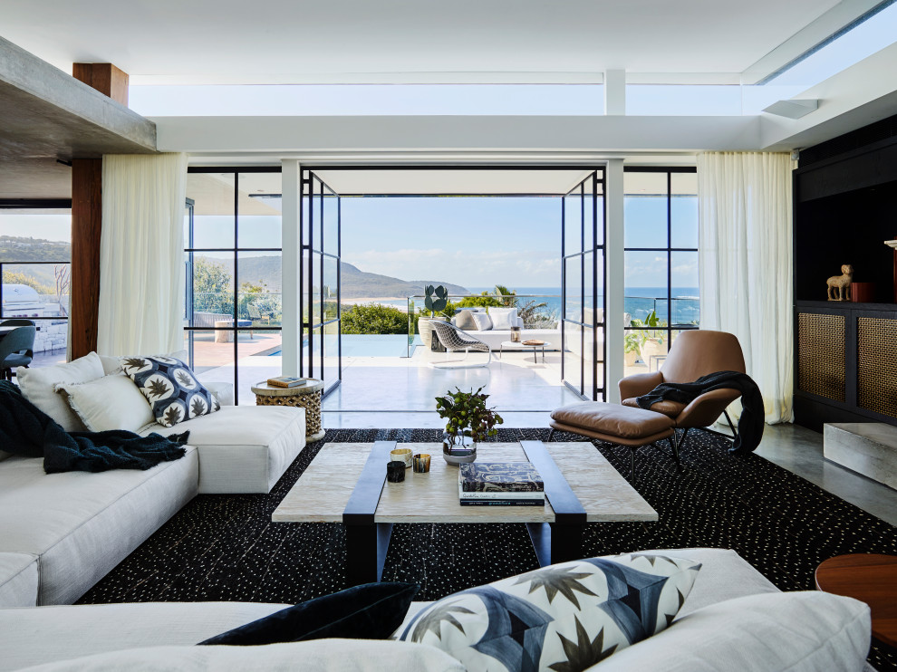 Идея дизайна: открытая гостиная комната в современном стиле с бетонным полом и серым полом