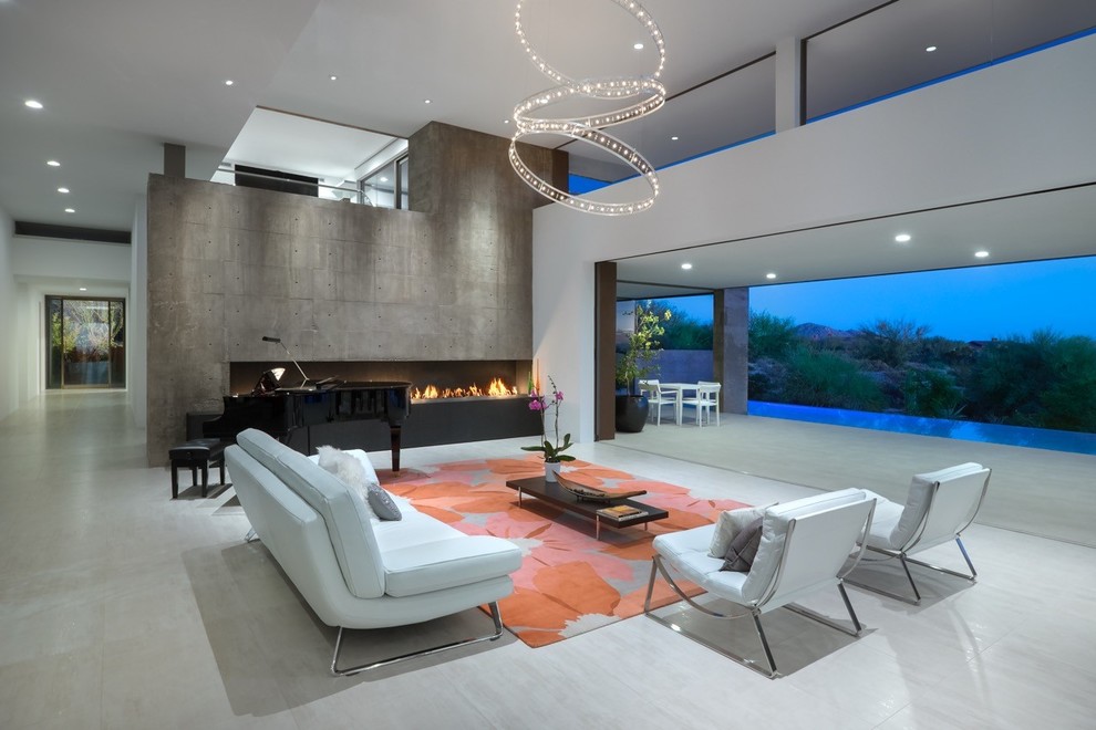 フェニックスにあるラグジュアリーな広いサンタフェスタイルのおしゃれなリビング (白い壁、横長型暖炉、コンクリートの暖炉まわり、コンクリートの床、テレビなし、グレーの床) の写真