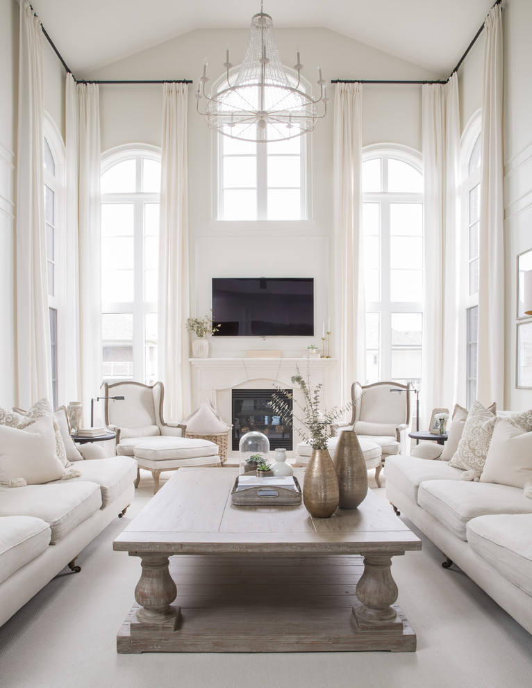 Example of a classic white floor and carpeted living room design in Toronto with white walls, a standard fireplace and a wall-mounted tv