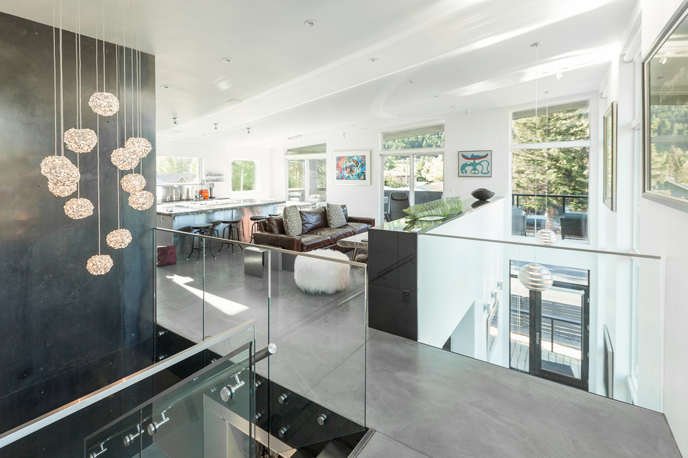 Contemporary mezzanine living room in Salt Lake City with white walls.