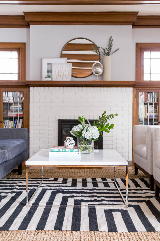 Inspiration for a small 1960s formal and enclosed light wood floor and brown floor living room remodel in Minneapolis with white walls, a standard fireplace, a brick fireplace and no tv