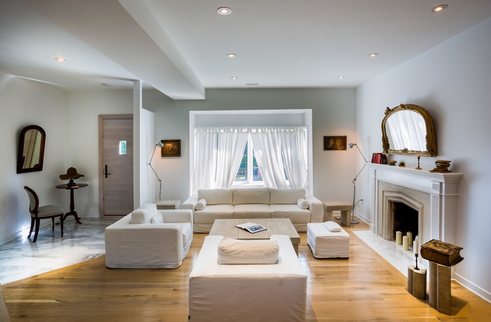 Стильный дизайн: большая открытая гостиная комната в современном стиле с белыми стенами, светлым паркетным полом, стандартным камином и фасадом камина из камня без телевизора - последний тренд