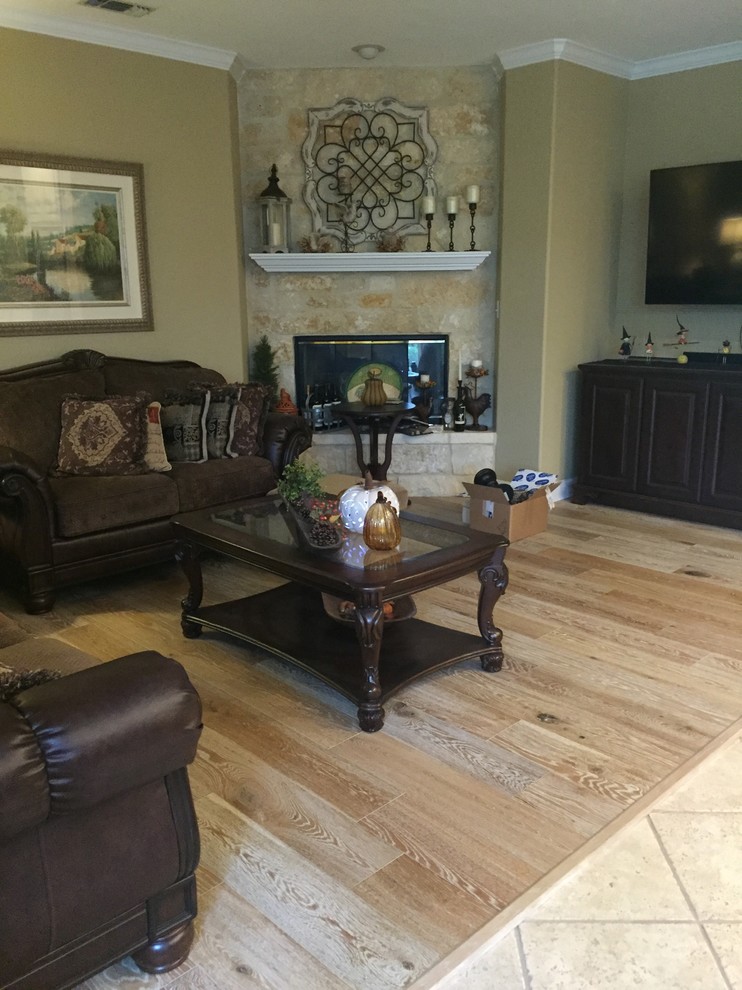 This is an example of a medium sized rustic enclosed living room in Austin with beige walls, light hardwood flooring, a corner fireplace, a stone fireplace surround and no tv.