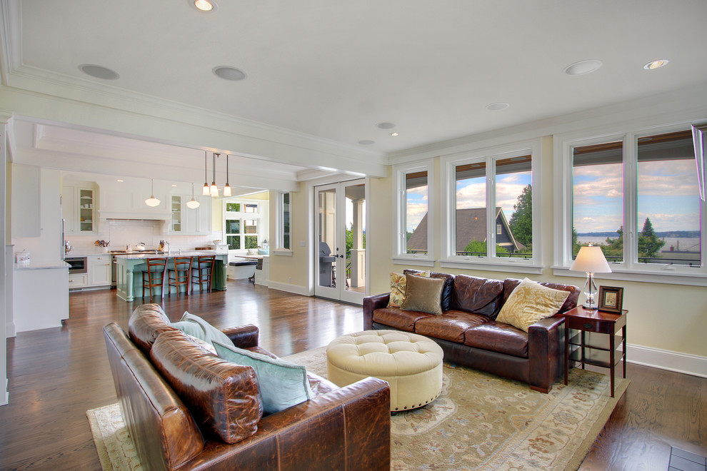 Elegant open concept living room photo in Seattle with yellow walls