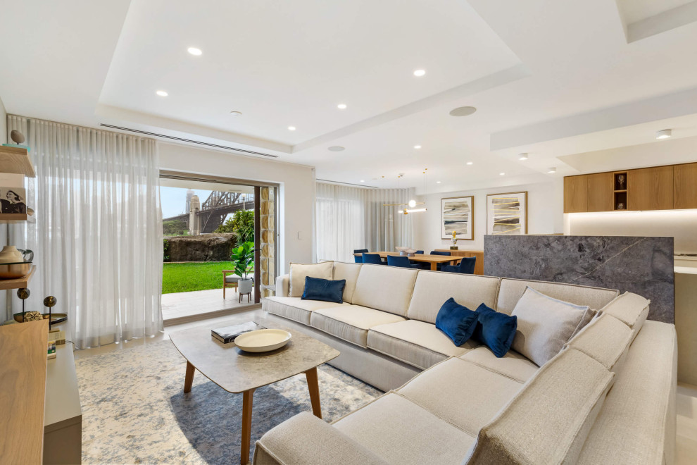Example of a mid-sized trendy open concept ceramic tile and tray ceiling living room design in Sydney with white walls