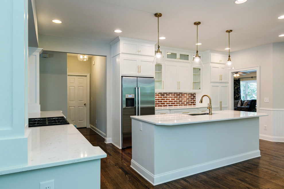 Example of a mid-sized arts and crafts medium tone wood floor and brown floor kitchen design in Atlanta