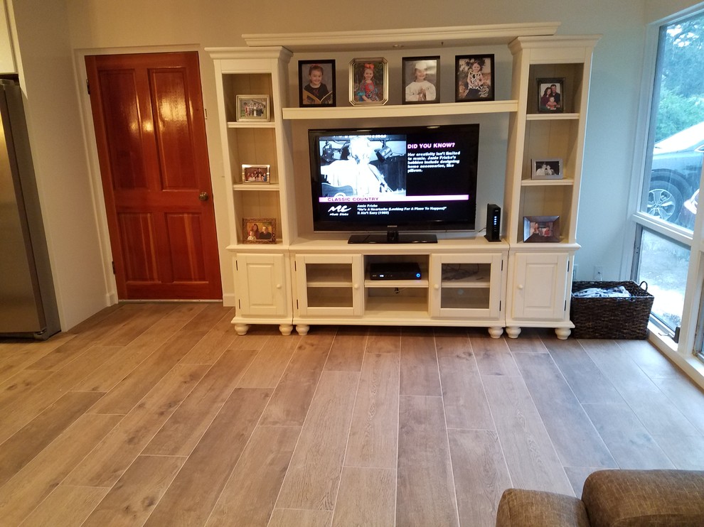 Mid-sized transitional formal and open concept medium tone wood floor and brown floor living room photo in Tampa with white walls, no fireplace and a tv stand