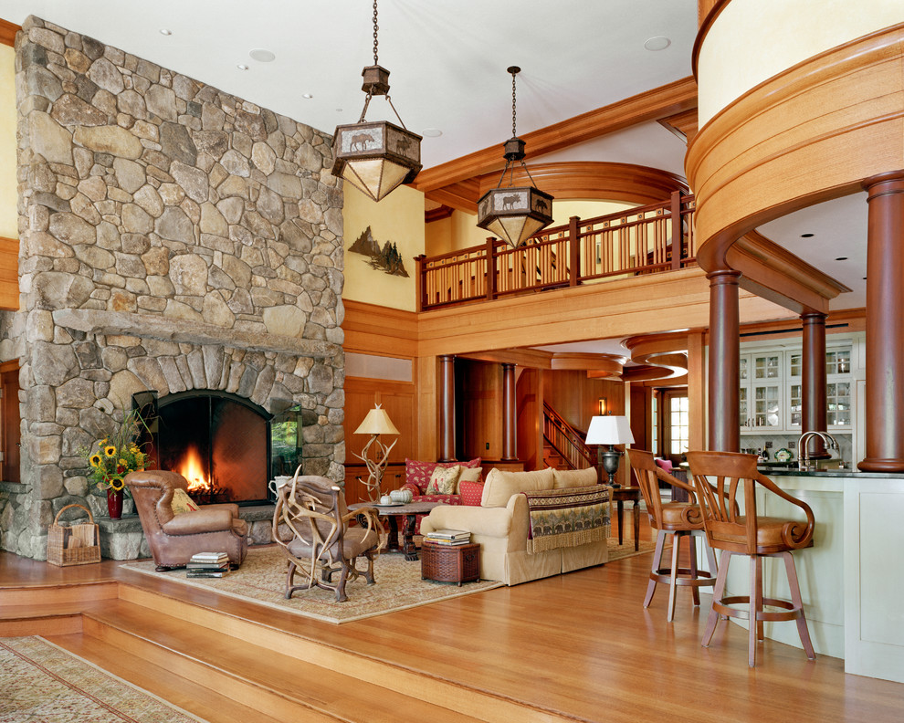Living room - traditional open concept medium tone wood floor living room idea in Boston with beige walls, a standard fireplace and a stone fireplace